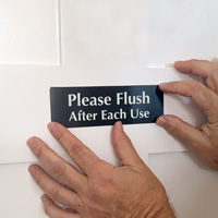 Please flush after each use sign on a door