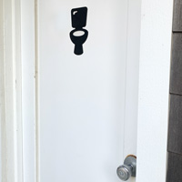 Die cut restroom marker with adhesive backing