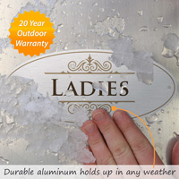 Metallic ladies restroom sign